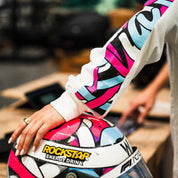 Hoonigan x Lia Block SCRIPT Long Sleeve T-Shirt featuring vibrant graphics and a close-up of a colorful helmet.