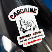Hoonigan CARCAINE SUPPORT GROUP sticker featuring a cartoon character and a donut, promoting automotive humor.