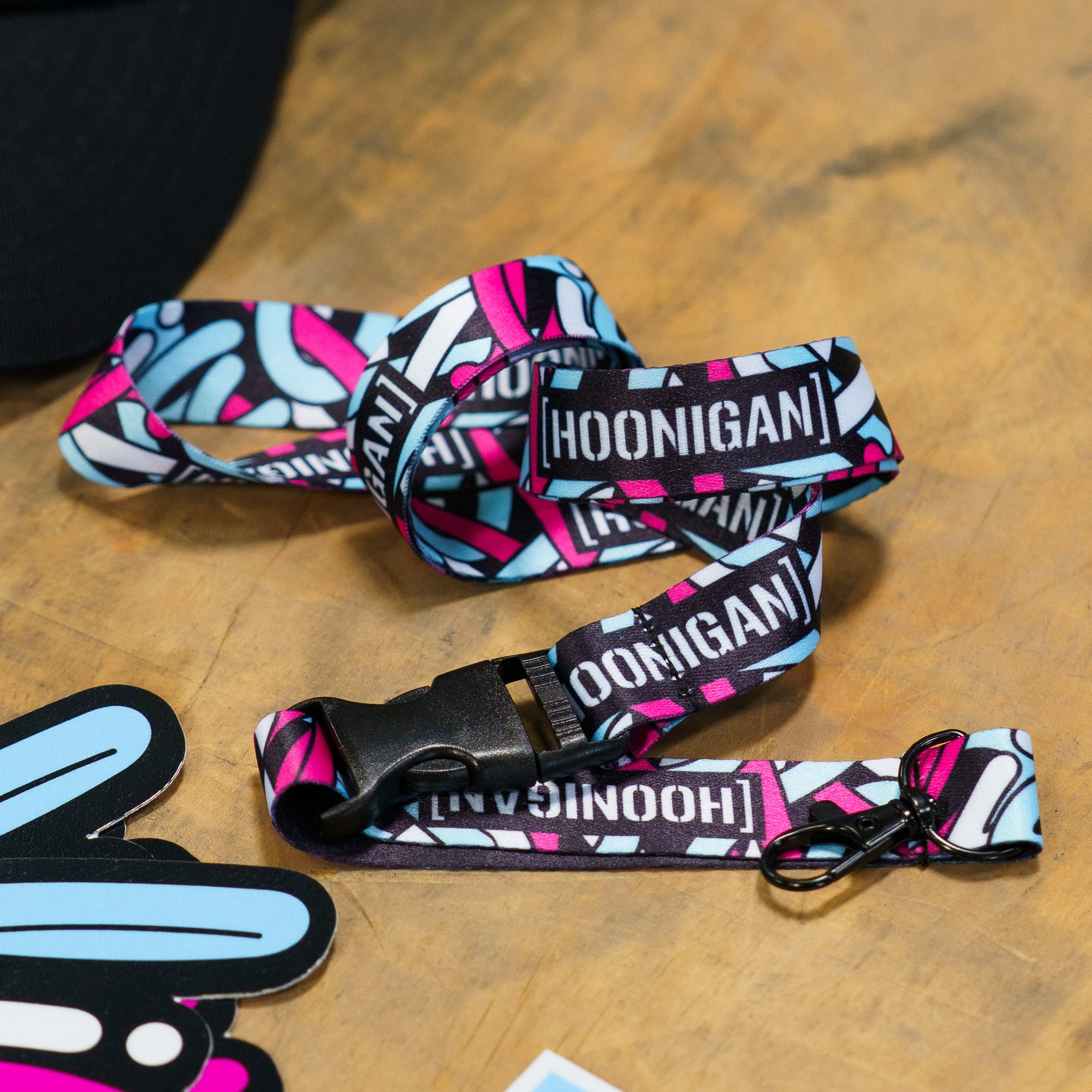 Colorful Hoonigan x Lia Block SCRIPT lanyard featuring bold branding and a stylish design, perfect for motorsport enthusiasts.