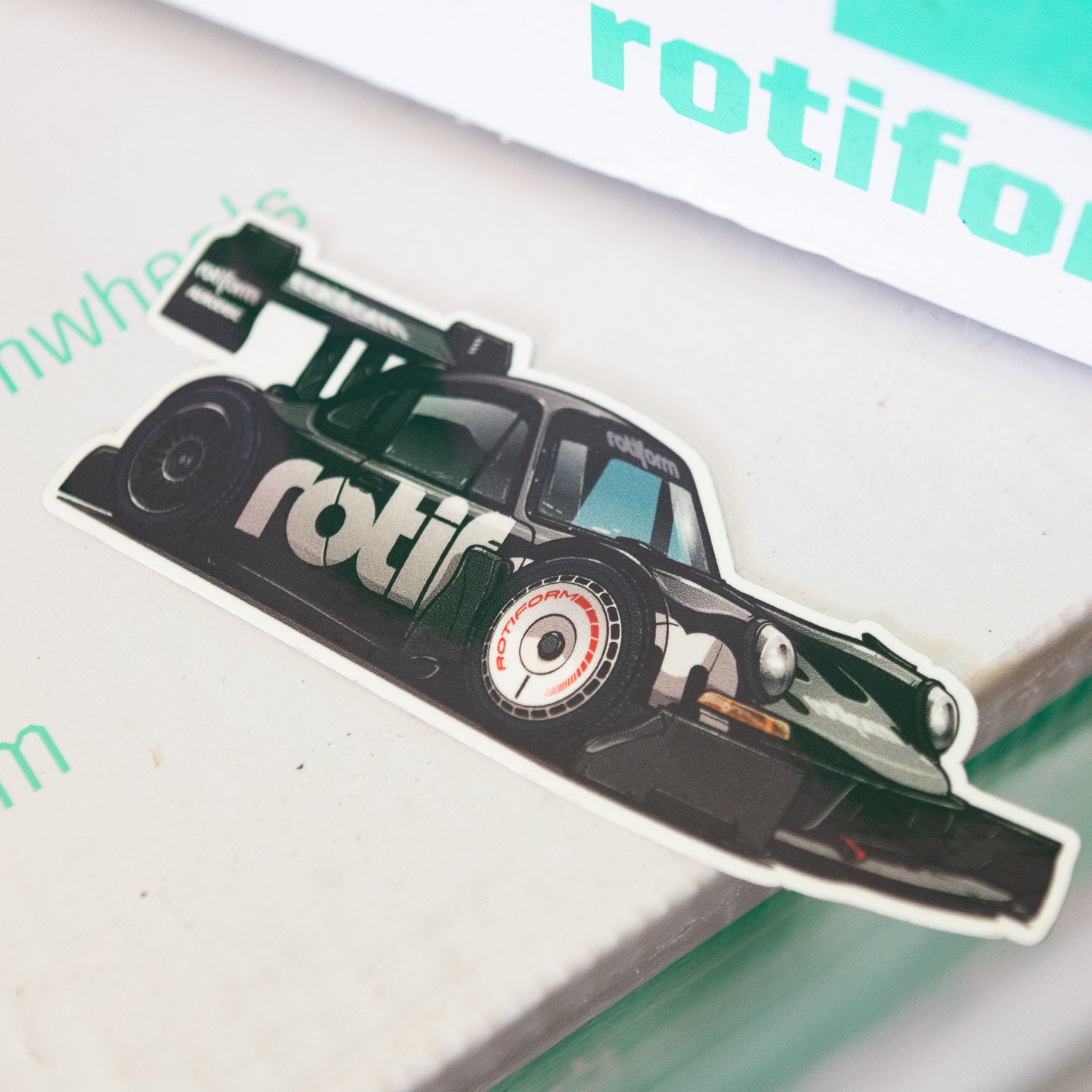 Hoonigan x Rotiform SD sticker featuring a stylized racing car design, perfect for automotive enthusiasts.