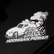 Hoonigan ON SITE sticker featuring a car with smoke and the text "Hoonigan Power" in bold lettering.