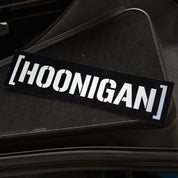Black Hoonigan CENSOR BAR sticker displayed on a textured surface, perfect for automotive enthusiasts and car culture fans.