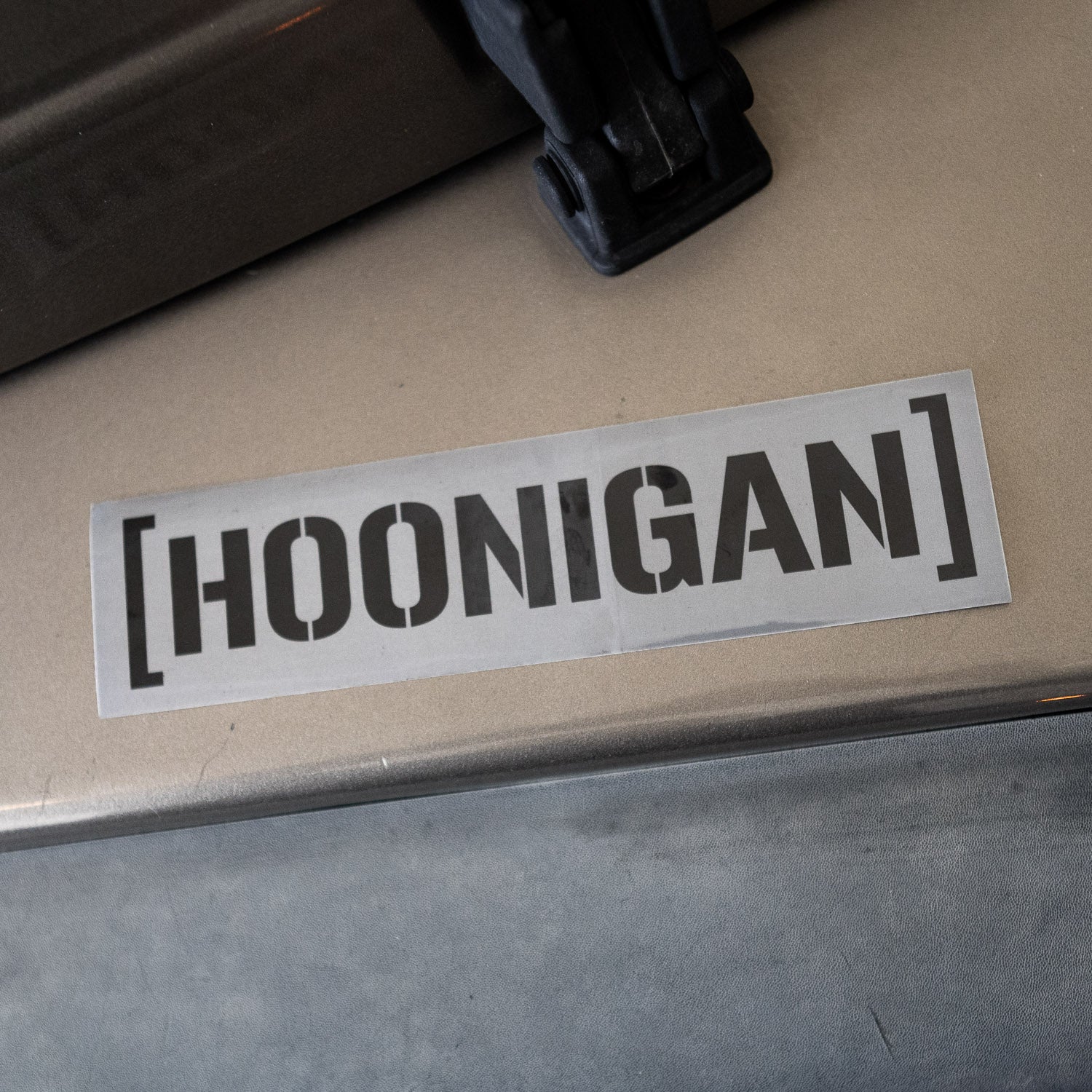 Hoonigan BEAMS CENSOR BAR sticker featuring bold black lettering on a silver background, perfect for car enthusiasts.