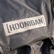Hoonigan CENSOR BAR backpack featuring a bold logo, designed for automotive enthusiasts and outdoor adventures.