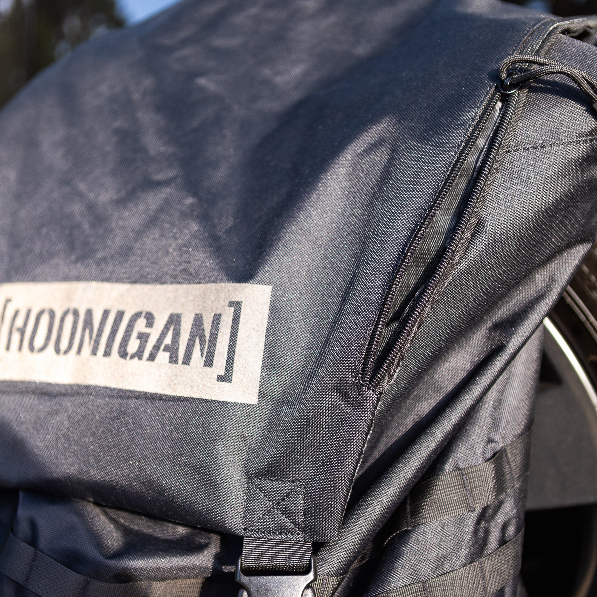 Hoonigan CENSOR BAR spare tire backpack featuring durable fabric and adjustable straps for automotive enthusiasts.