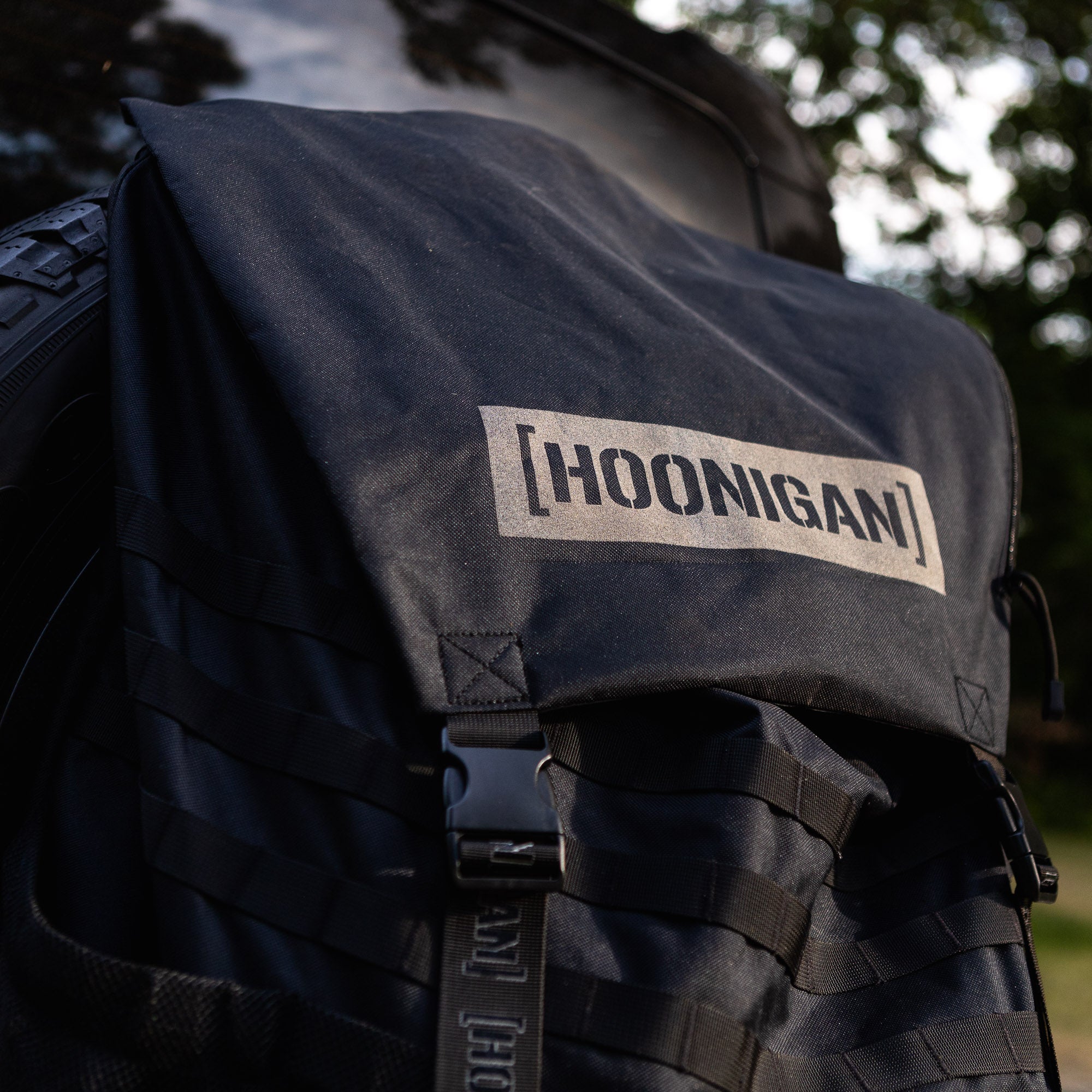 Hoonigan CENSOR BAR spare tire backpack featuring durable fabric and adjustable straps for automotive enthusiasts.