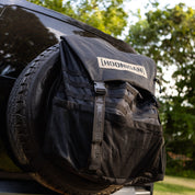 Hoonigan CENSOR BAR spare tire backpack featuring durable fabric and adjustable straps for automotive enthusiasts.