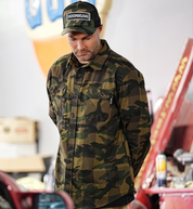 Hoonigan H Icon Camo Woven Flannel Long Sleeve Shirt featuring a camo pattern and Hoonigan logo, displayed on a wooden background.