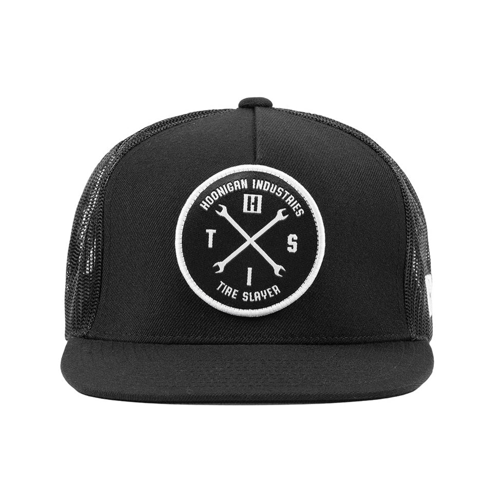 Black and white Hoonigan HITS v2 trucker hat with a front logo patch and adjustable snapback closure.