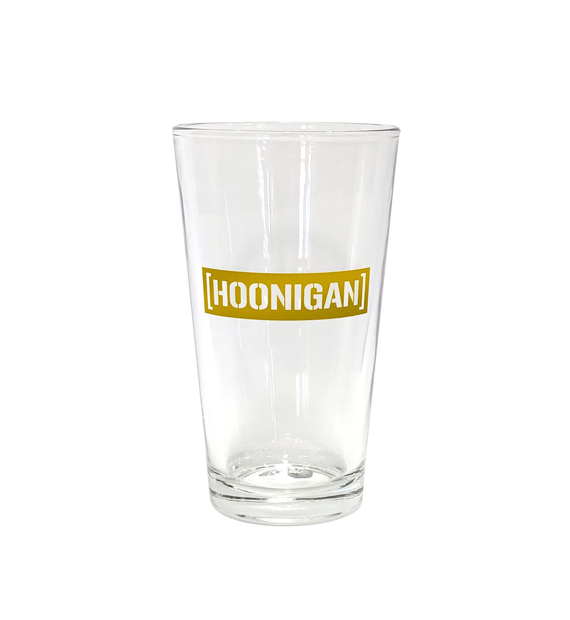 Clear pint glass featuring a bold gold Hoonigan logo, perfect for enjoying beverages while celebrating car culture.