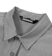 Hoonigan DONUT GARAGE gray woven short sleeve button-up shirt with contrasting logo detail on chest.