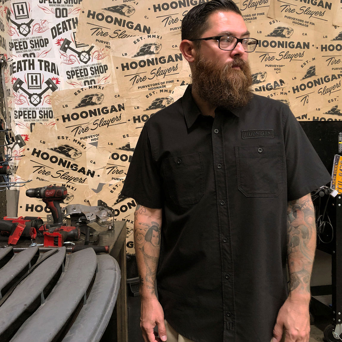 Hoonigan DONUT GARAGE black woven short sleeve button-up shirt with logo detailing.