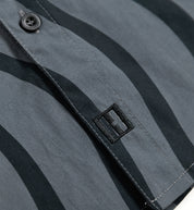 Hoonigan ESSES Woven Short Sleeve Button-up Shirt in black and grey, featuring a sleek design with a modern fit and button-up collar.