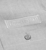 Hoonigan DONUT GARAGE woven long sleeve button-up shirt in heather gray, featuring a button-down collar and a front pocket with logo detail.