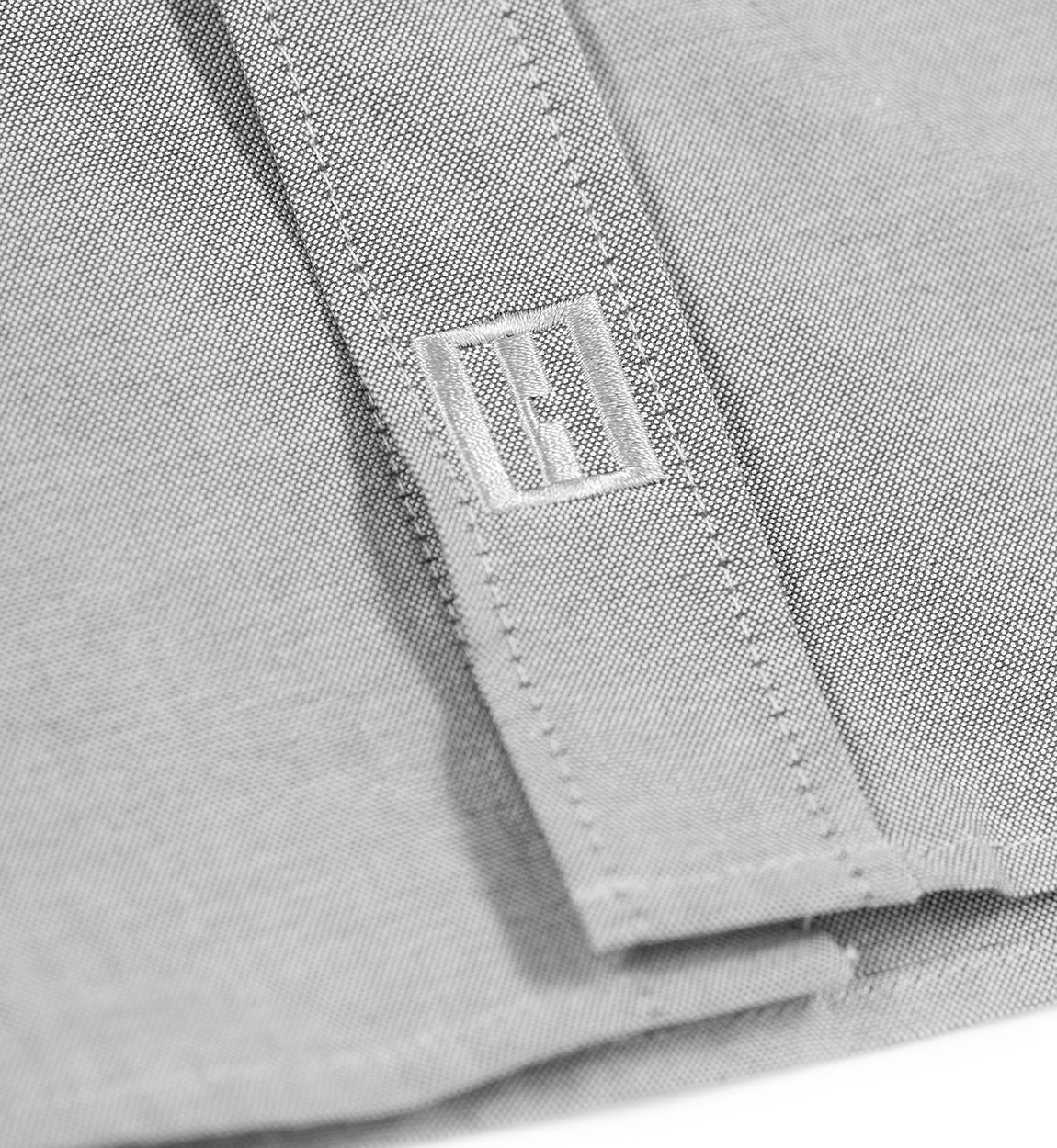 Hoonigan DONUT GARAGE woven long sleeve button-up shirt in heather gray, featuring a classic collar and front button closure.