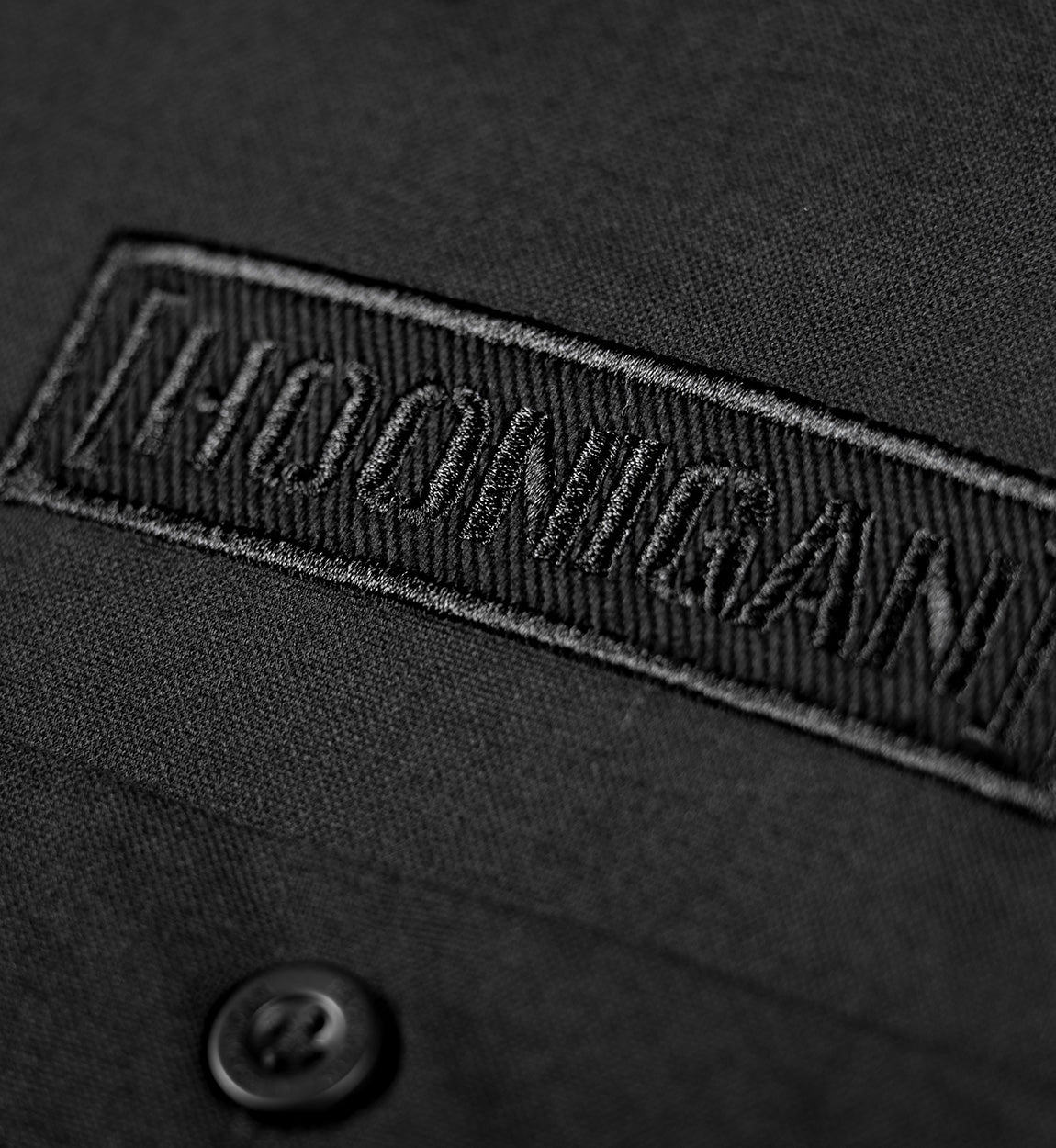 Hoonigan DONUT GARAGE black woven long sleeve button-up shirt featuring a stylish graphic design.
