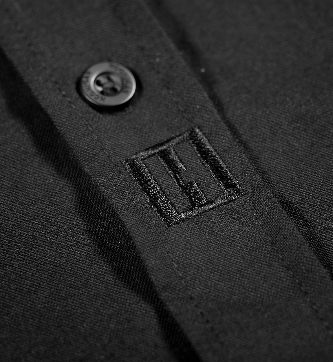 Hoonigan DONUT GARAGE black woven long sleeve button-up shirt featuring a collar and custom graphic print.