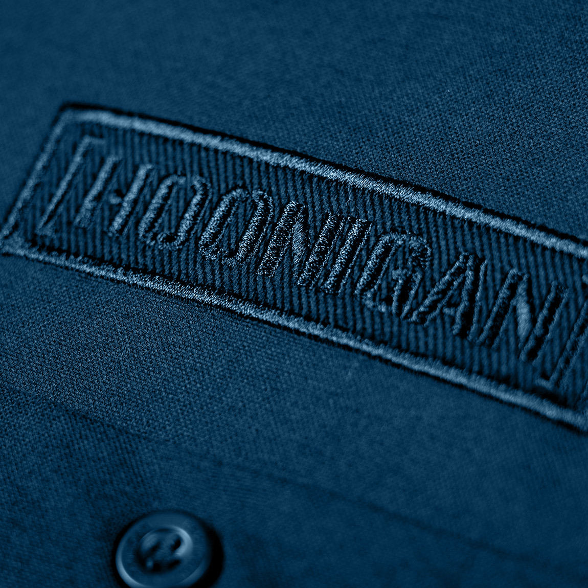 Hoonigan DONUT GARAGE Woven Long Sleeve Button-up Shirt in navy blue, featuring a front pocket and a classic button-up design.