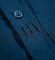 Hoonigan DONUT GARAGE woven long sleeve button-up shirt in navy, featuring a classic collar and button-down front with subtle logo detailing.
