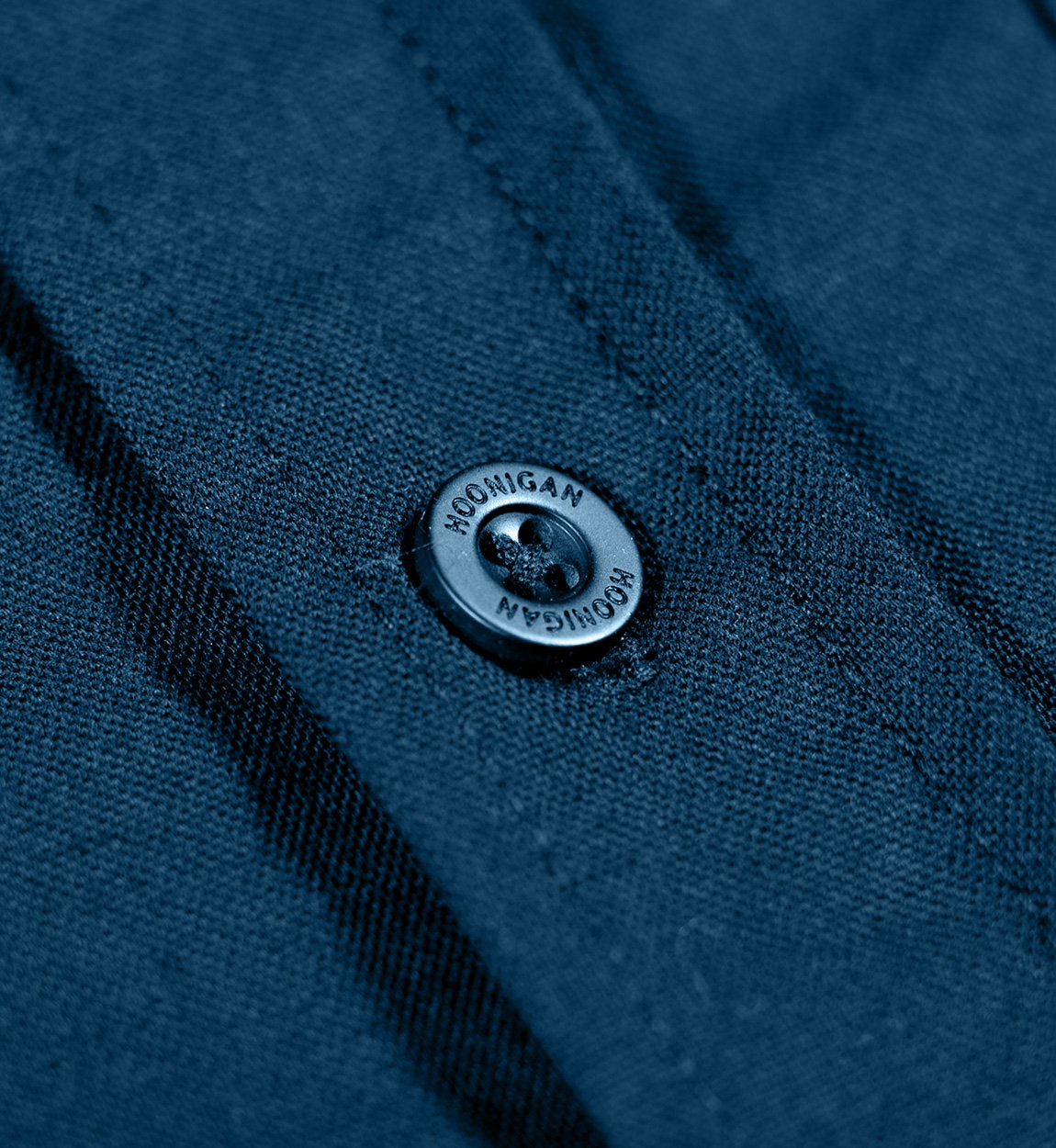 Hoonigan DONUT GARAGE navy woven long sleeve button-up shirt featuring a front button closure and logo detail.