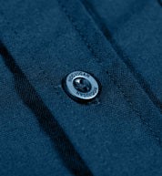 Hoonigan DONUT GARAGE navy woven long sleeve button-up shirt featuring a front button closure and logo detail.