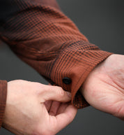 Hoonigan RUST Long Sleeve Flannel Shirt in black and rust colors, featuring a plaid pattern and button-up front.