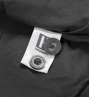 Hoonigan CHORE Jacket in black, featuring a front button closure, two chest pockets, and an embroidered logo on the left breast.