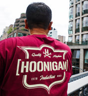 Hoonigan EMBLEM Short Sleeve Tee in burgundy with a bold graphic logo on the front.