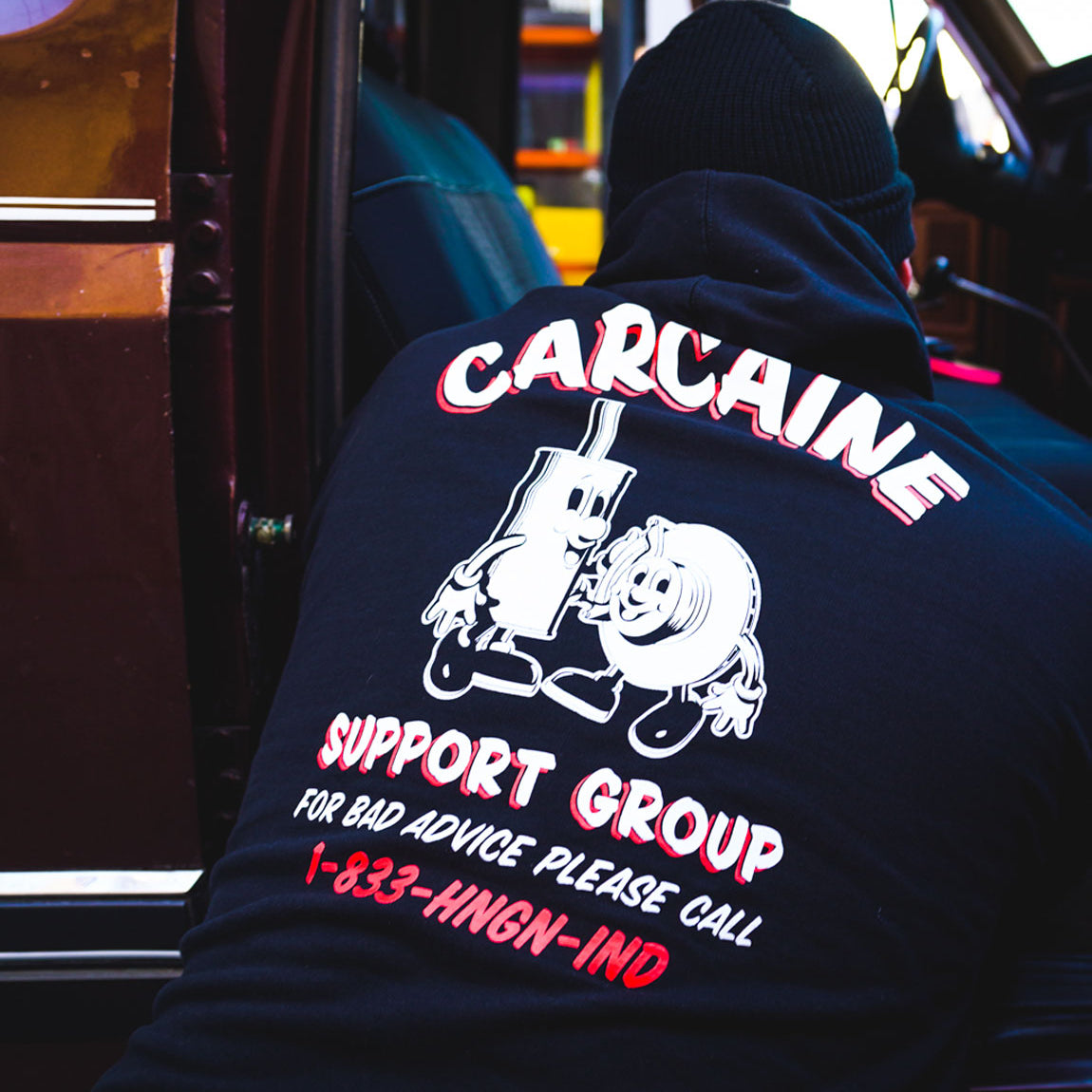 Hoonigan CARCAINE SUPPORT GROUP black pullover hoodie with white text and graphic design.