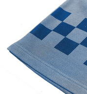 Hoonigan Tire Slayer Summer Camp shorts featuring a vibrant graphic design, elastic waistband, and side pockets, displayed on a wooden surface.