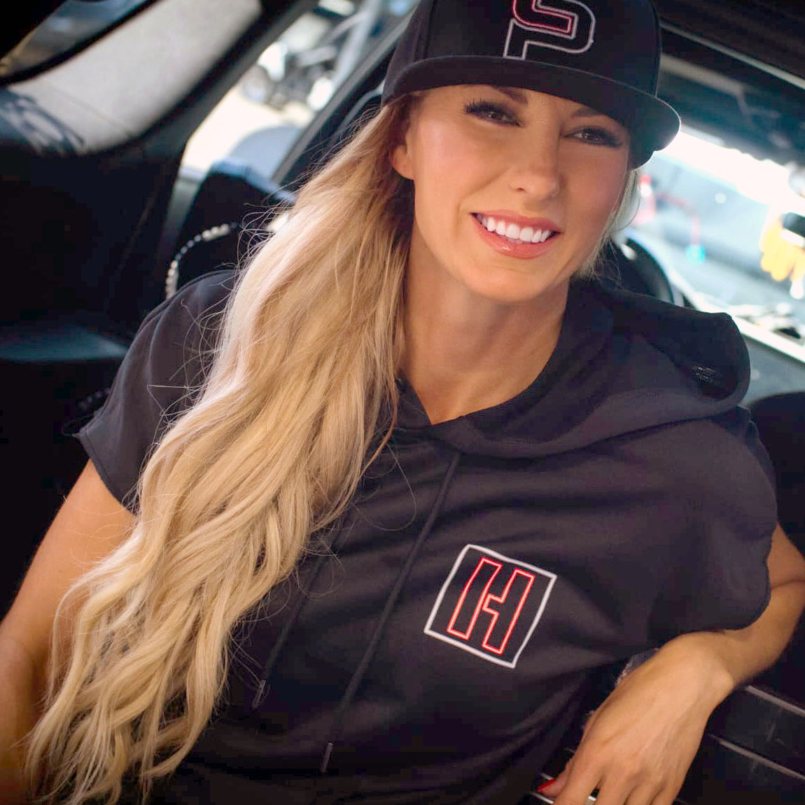 Black short sleeve pullover hoodie for women featuring Hoonigan and Leah Pruett LP ENERGY branding, perfect for casual wear.